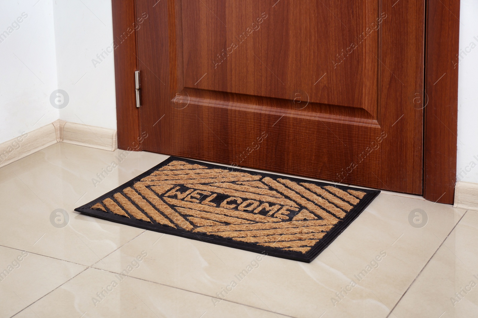 Photo of Brown welcome doormat at door in hall