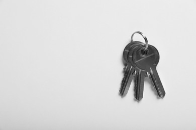 Keys on white background, top view and space for text. Real estate agent services