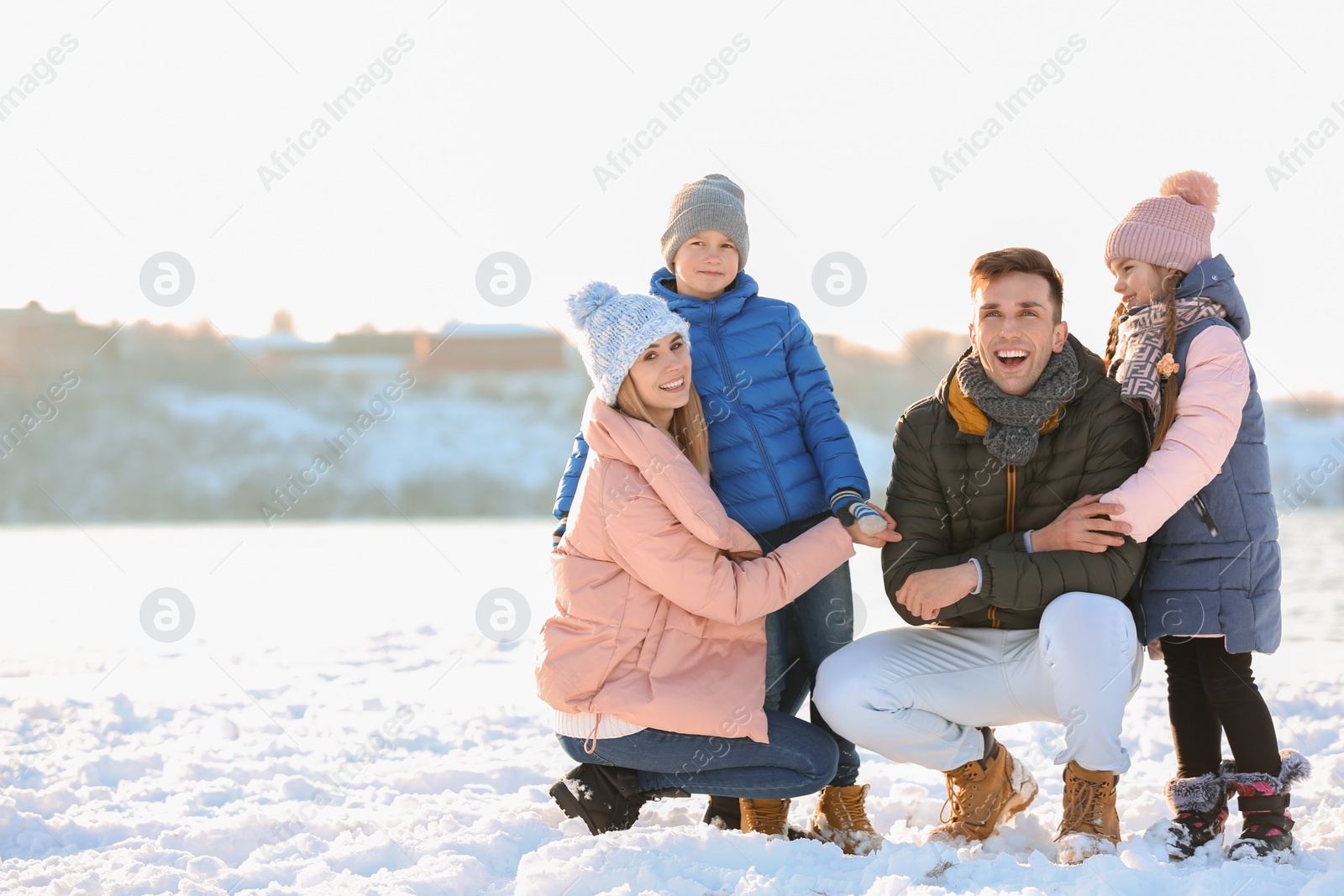 Photo of Portrait of happy family outdoors on winter day