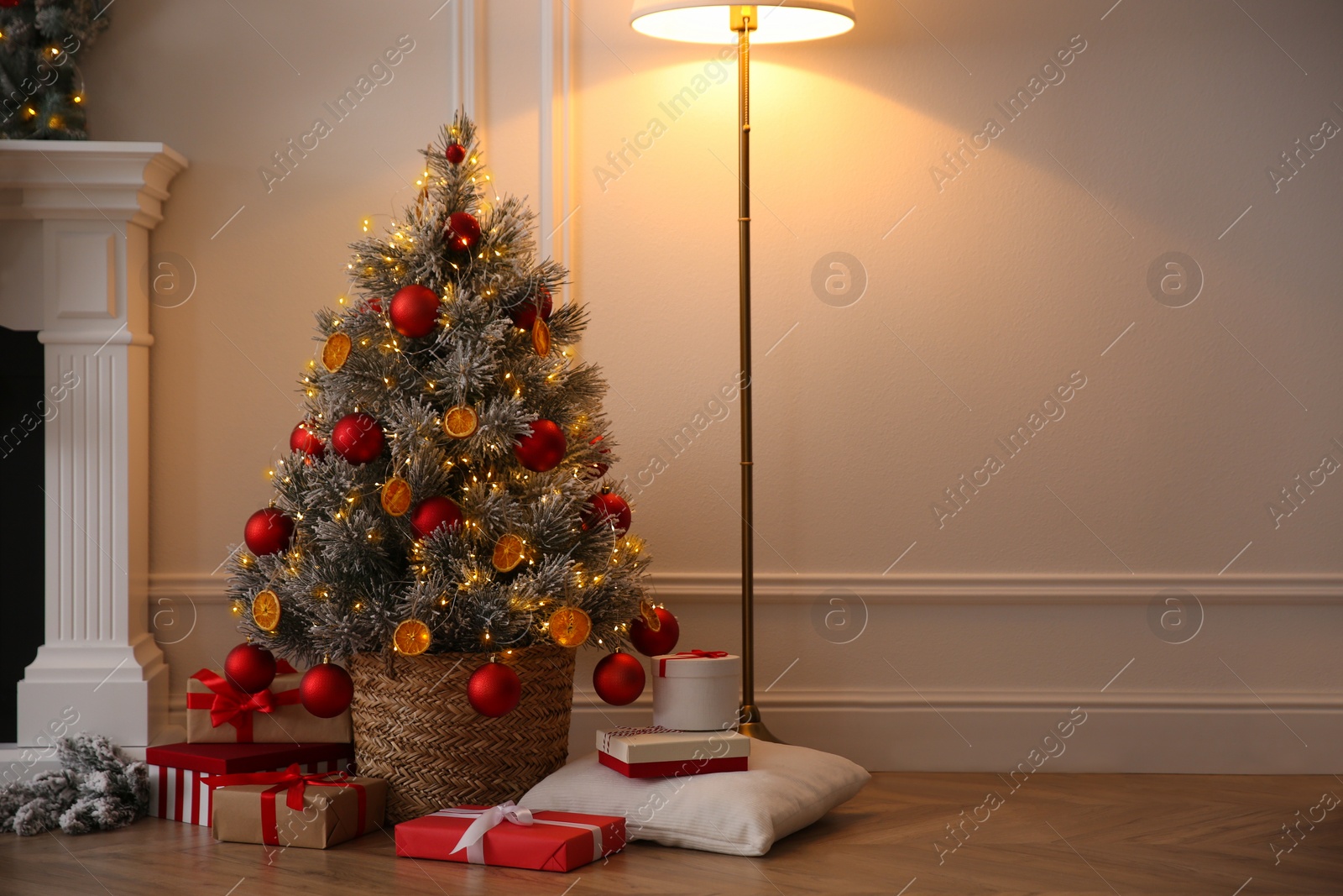 Photo of Beautiful Christmas tree and gift boxes in room. Space for text