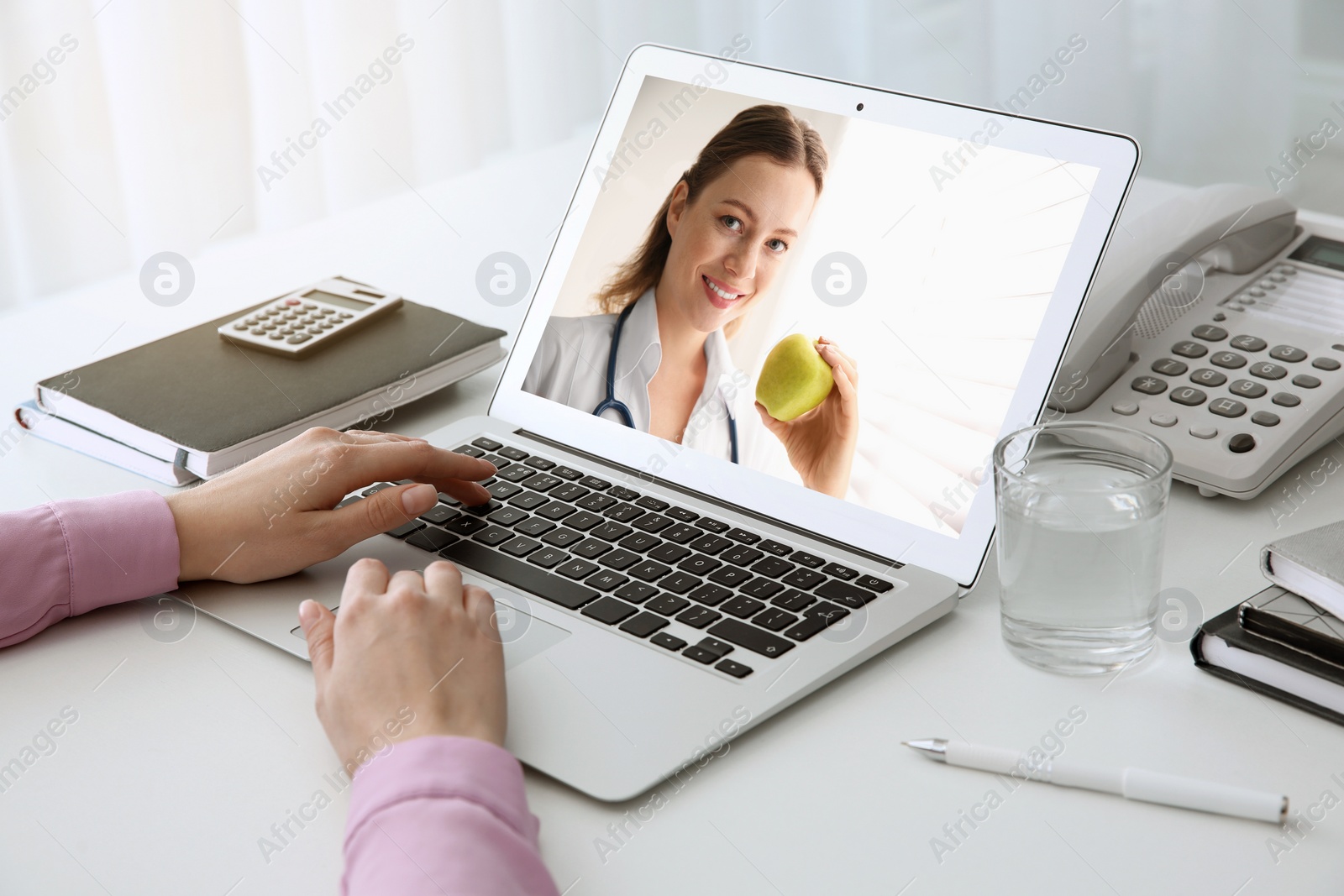 Image of Woman using laptop for online consultation with nutritionist via video chat, closeup