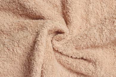 Photo of Soft crumpled beige towel as background, top view