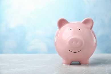 Photo of Pink piggy bank on table. Money saving