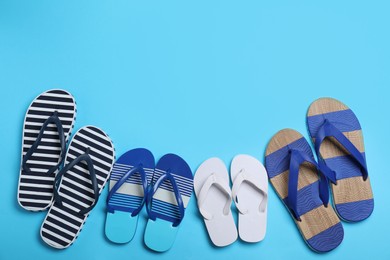 Photo of Many different stylish flip flops on light blue background, flat lay. Space for text