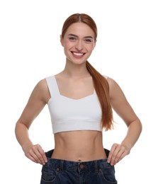 Photo of Slim woman wearing big jeans on white background. Weight loss