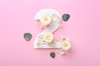 Photo of Paper number 2, eucalyptus leaves and beautiful flowers on pink background, flat lay