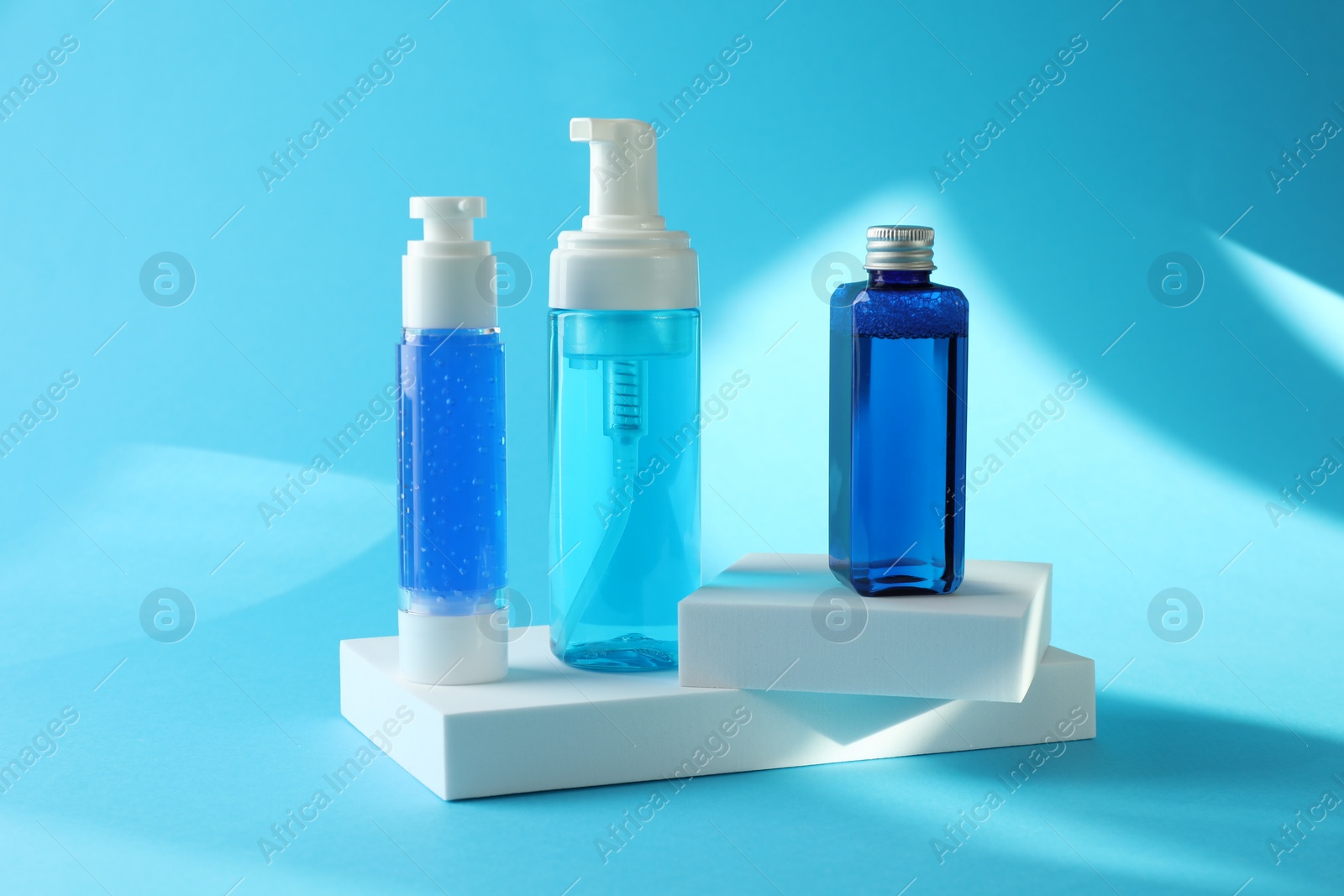 Photo of Set of luxury cosmetic products on light blue background