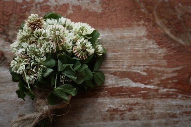 Bunch of beautiful clover plant on wooden table, top view. Space for text