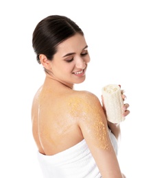 Photo of Young woman applying body scrub on her shoulder against white background