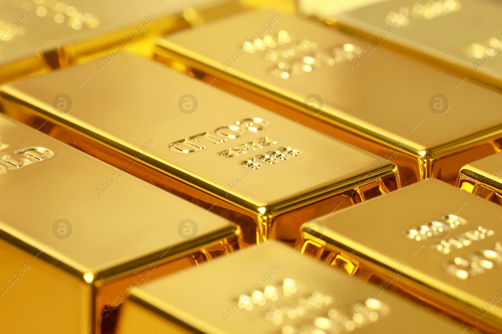 Photo of Many shiny gold bars as background, closeup