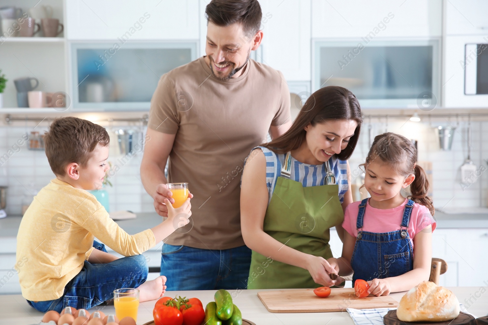 Photo of Happy family with children together in kitchen