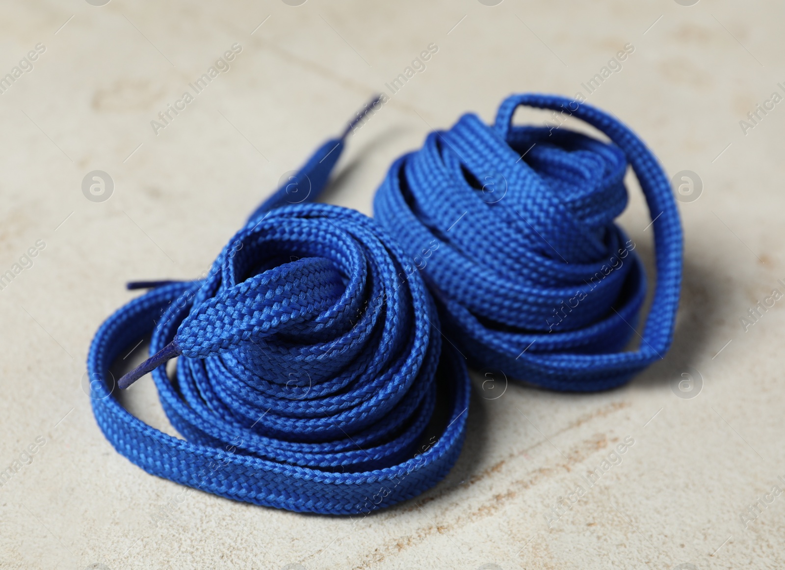 Photo of Blue shoelaces on light background. Stylish accessory
