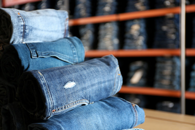 Rolled modern jeans in shop, closeup view