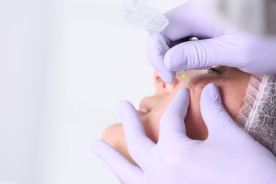 Photo of Woman undergoing face biorevitalization procedure in salon, closeup. Cosmetic treatment