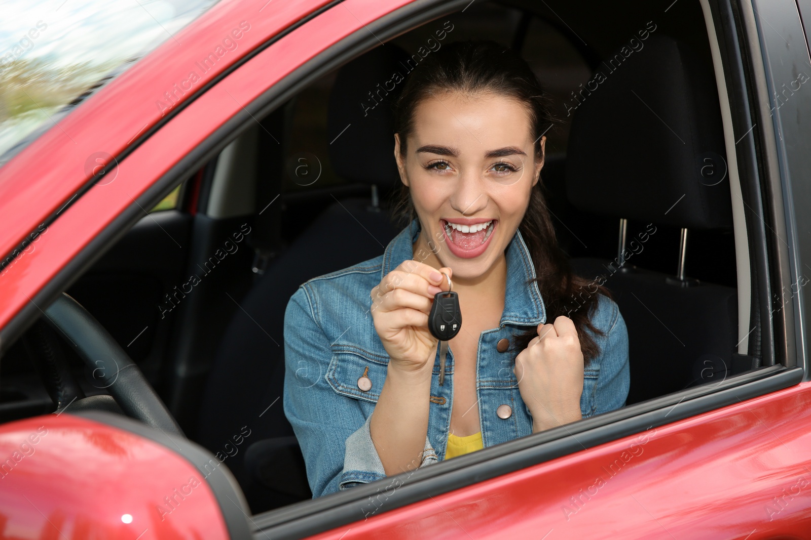 Photo of Happy woman showing key from new car