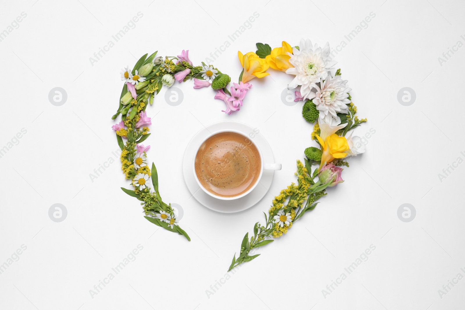 Photo of Beautiful heart made of different flowers and coffee  on white background, top view