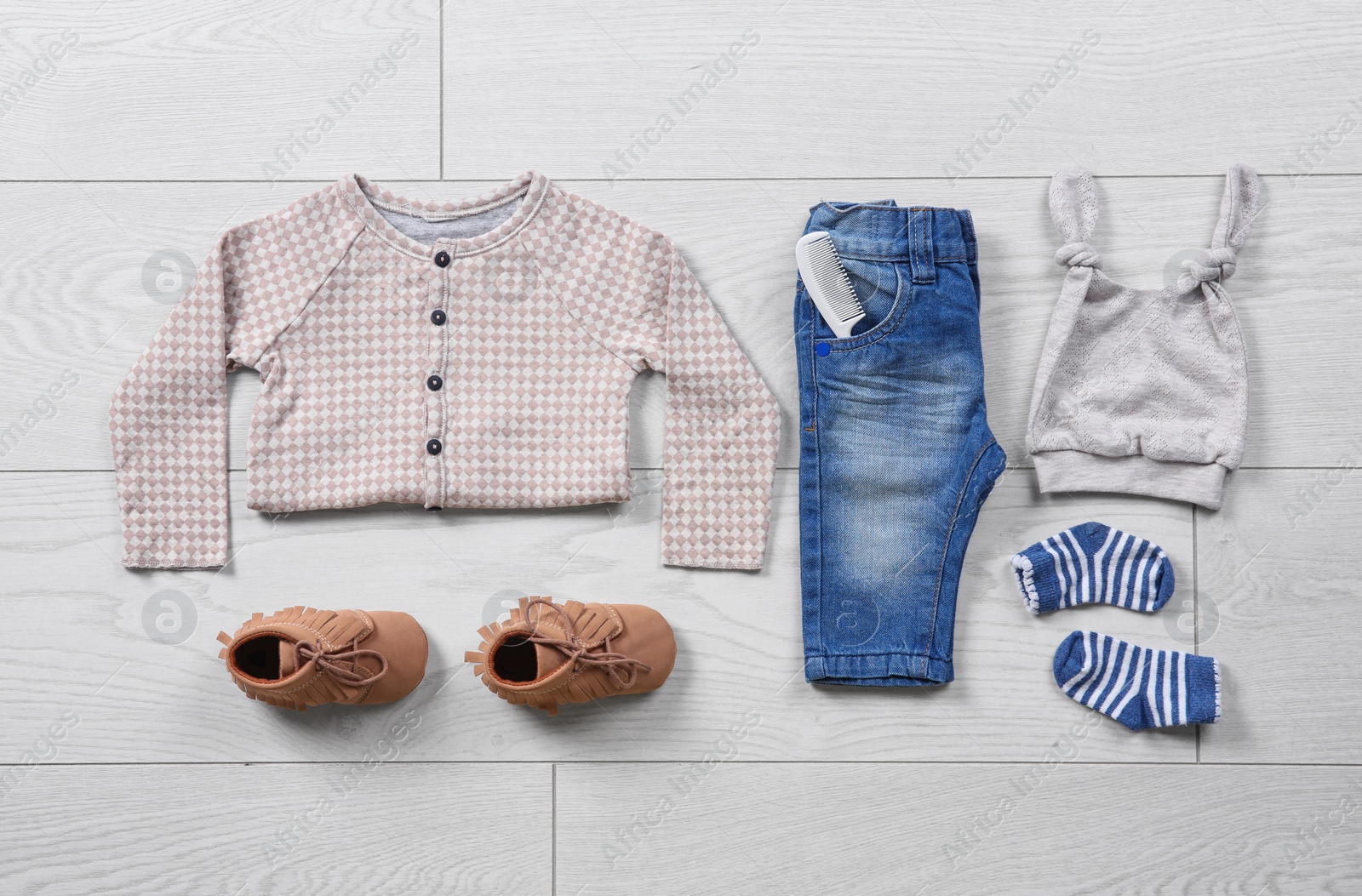 Photo of Flat lay composition with stylish child clothes on wooden background