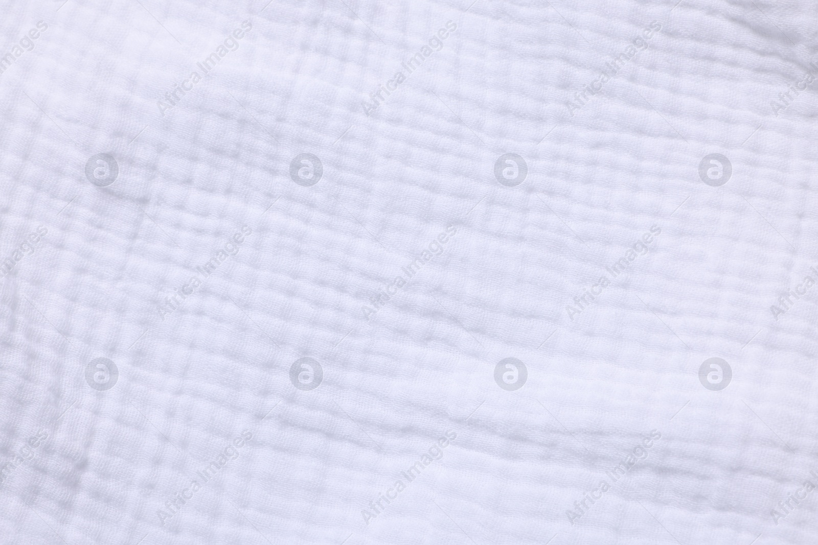 Photo of Texture of white fabric as background, top view