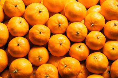 Photo of Delicious fresh ripe tangerines as background, top view