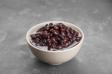Photo of Bowl of canned kidney beans on grey table