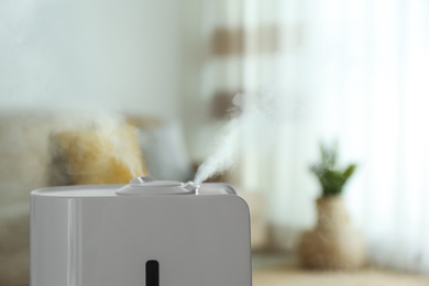 Photo of Modern air humidifier indoors, closeup. Space for text