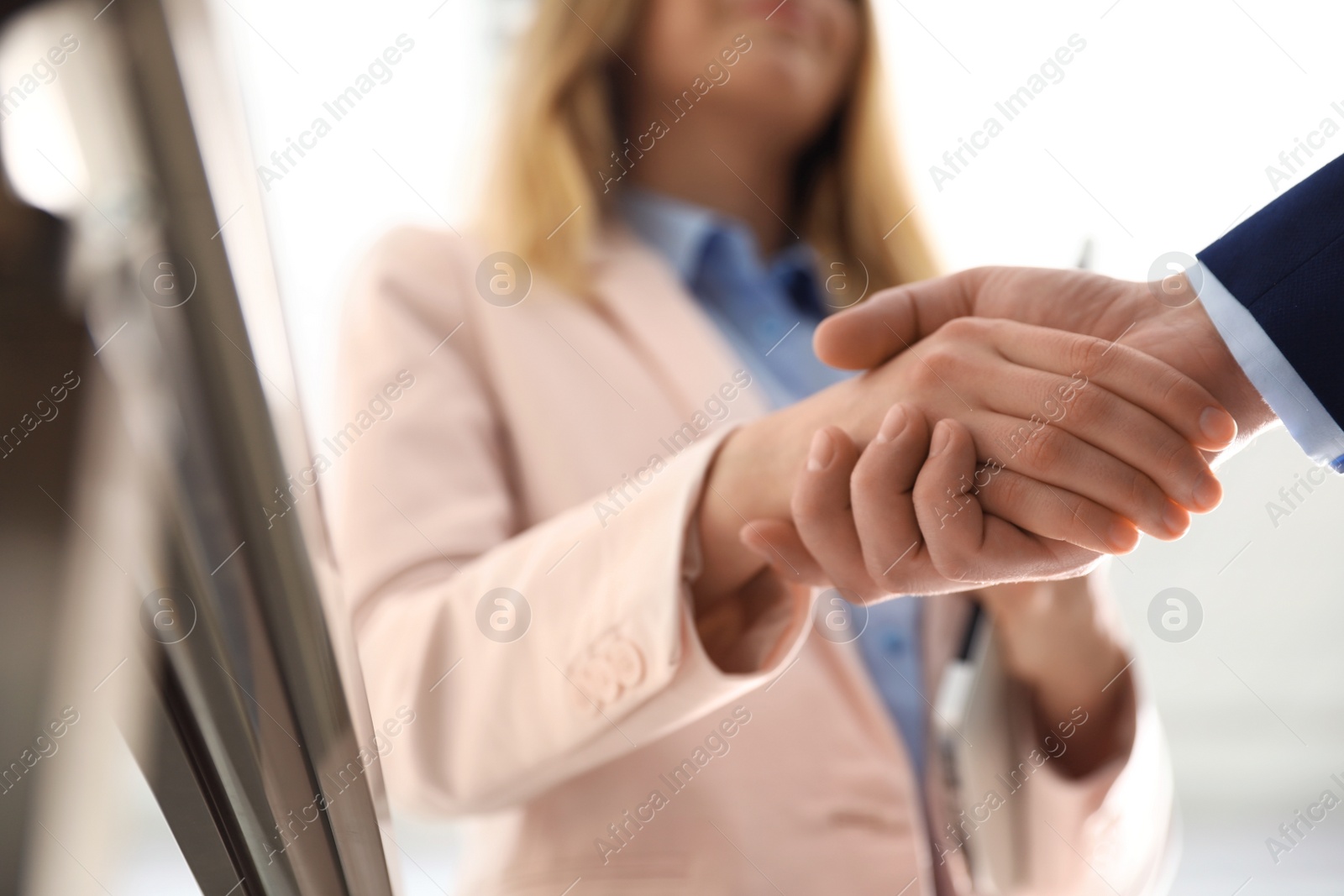 Photo of Business partners shaking hands after meeting, closeup