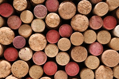 Many corks of wine bottles as background, top view