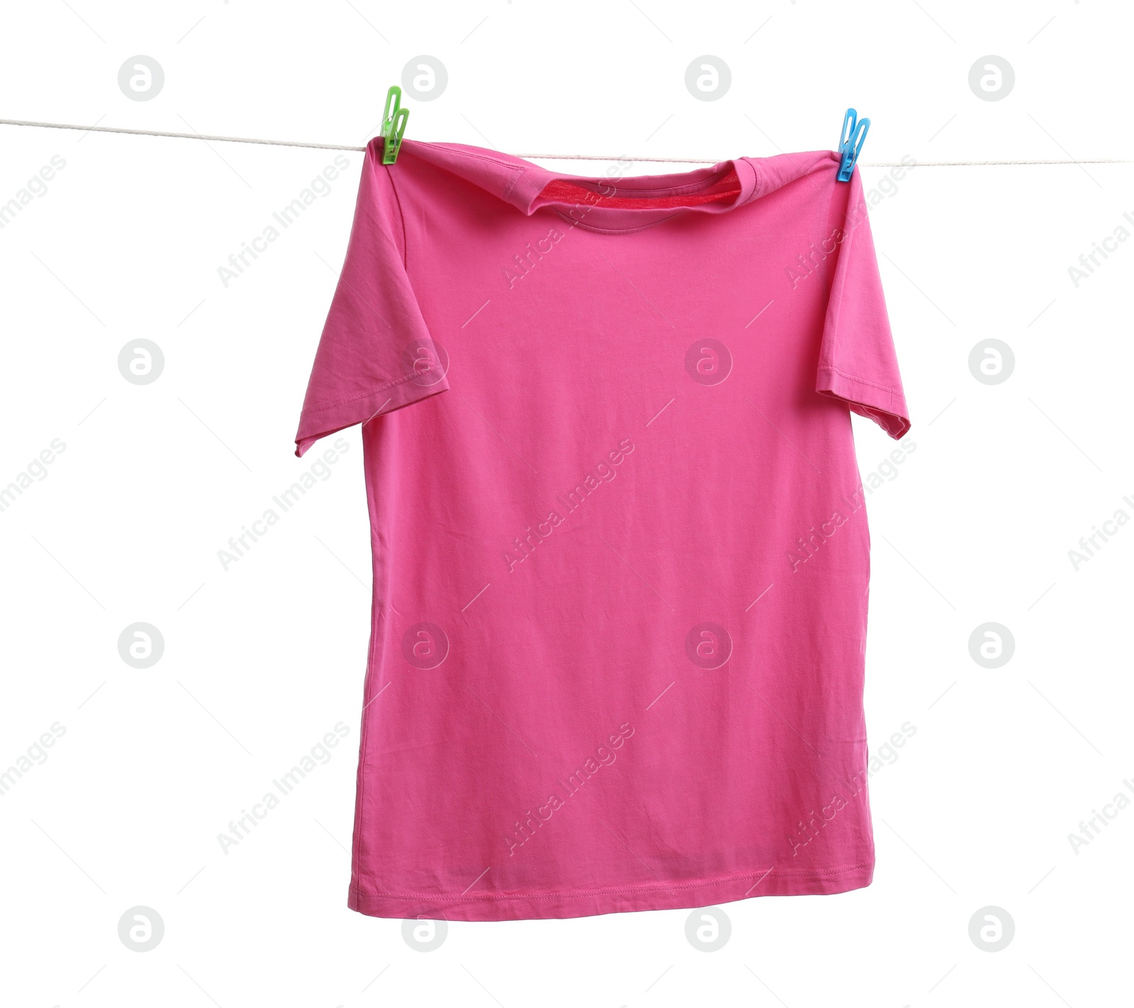 Photo of Pink t-shirt drying on washing line against white background