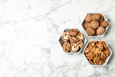 Flat lay composition with walnuts and space for text on marble background