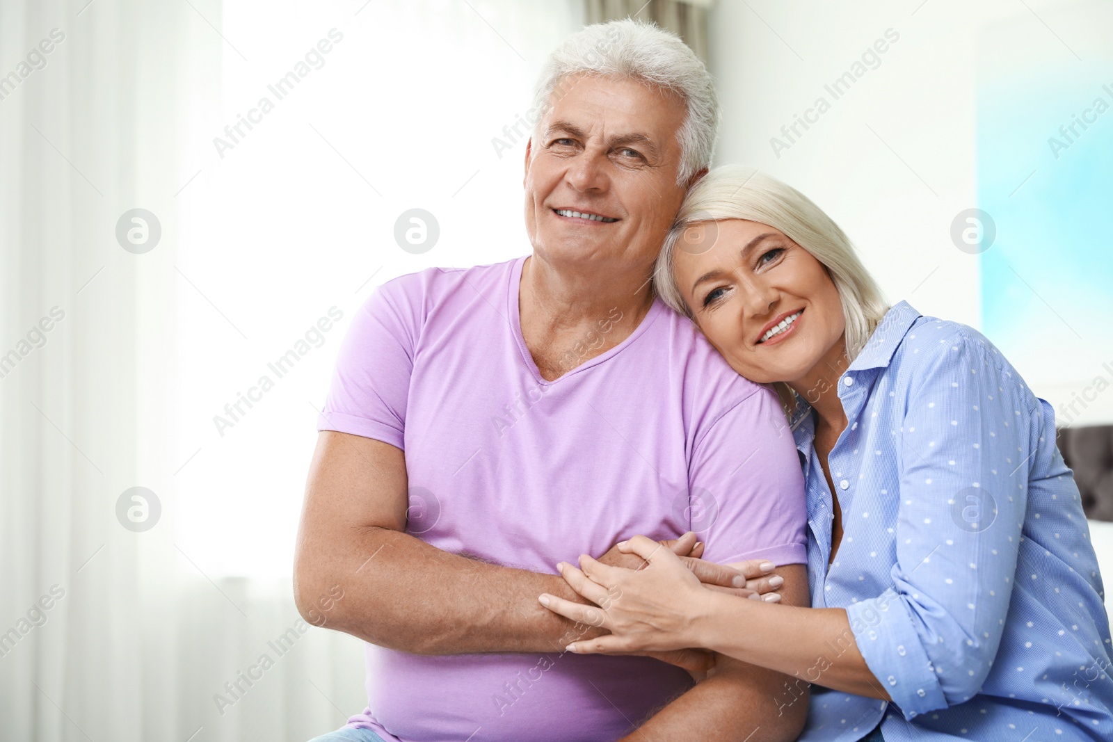 Photo of Portrait of happy senior couple at home