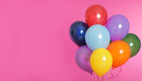 Bunch of bright balloons on color background. Space for text