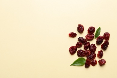 Photo of Cranberries on color background, top view with space for text. Dried fruit as healthy snack
