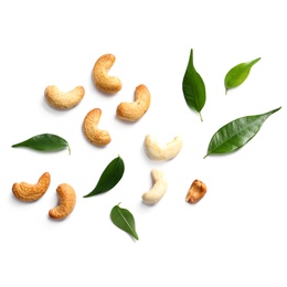 Photo of Tasty cashew nuts and leaves isolated on white, top view