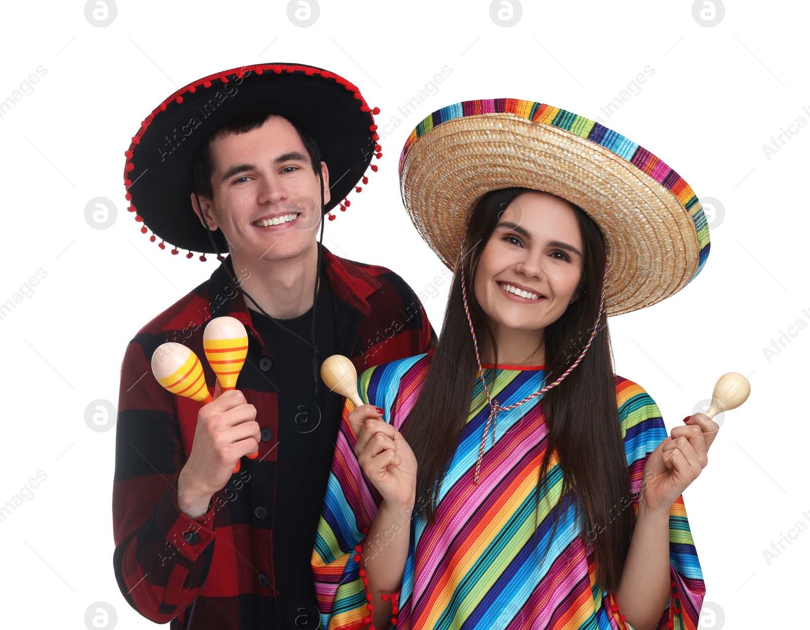 Photo of Lovely couple in Mexican sombrero hats with maracas on white background