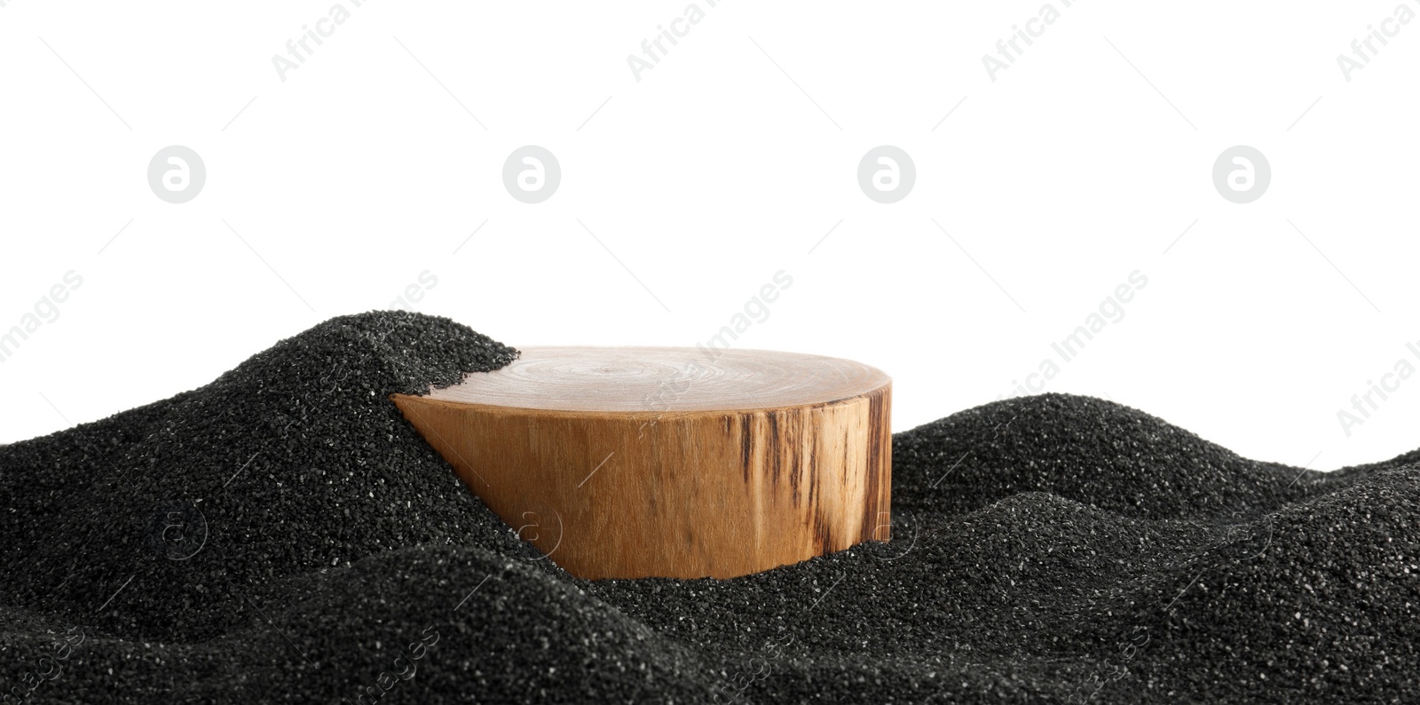 Photo of Presentation of product. Wooden podium on black sand against white background