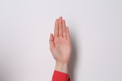Woman showing open palm on white background, closeup