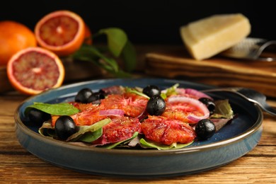 Photo of Plate of delicious sicilian orange salad on wooden table, closeup. Space for text