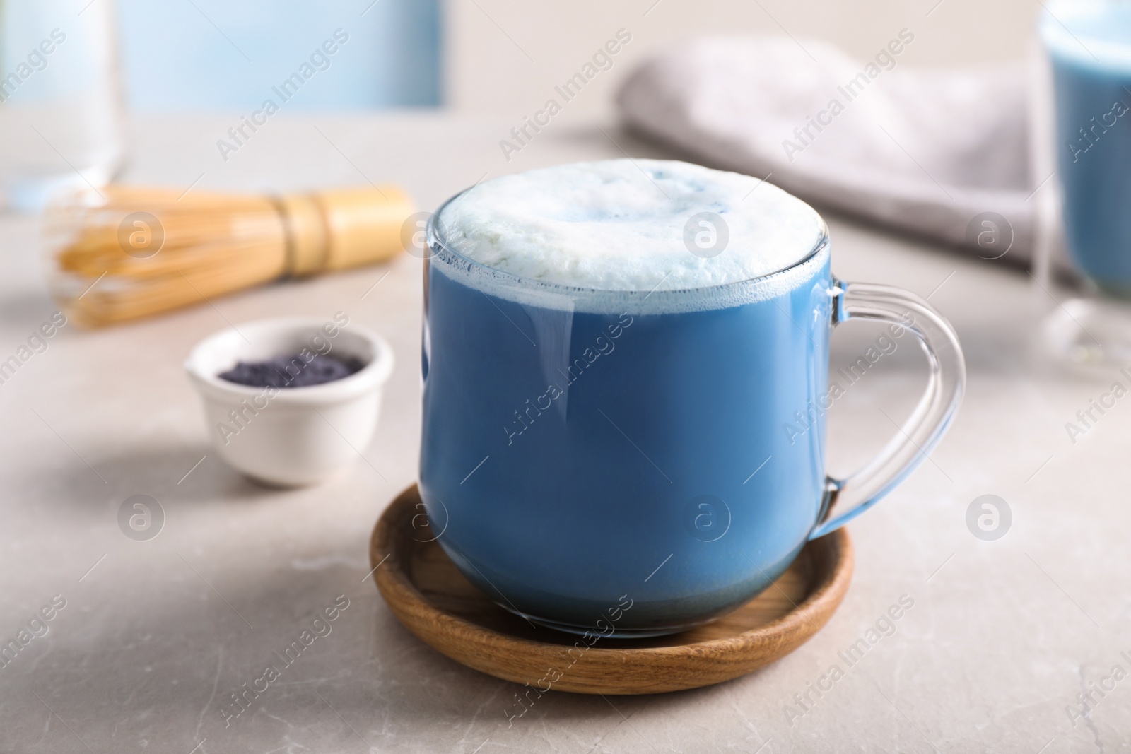 Photo of Delicious blue matcha drink on light grey table