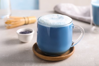 Delicious blue matcha drink on light grey table