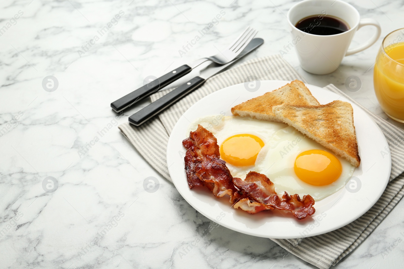 Photo of Delicious breakfast with sunny side up eggs served on white marble table