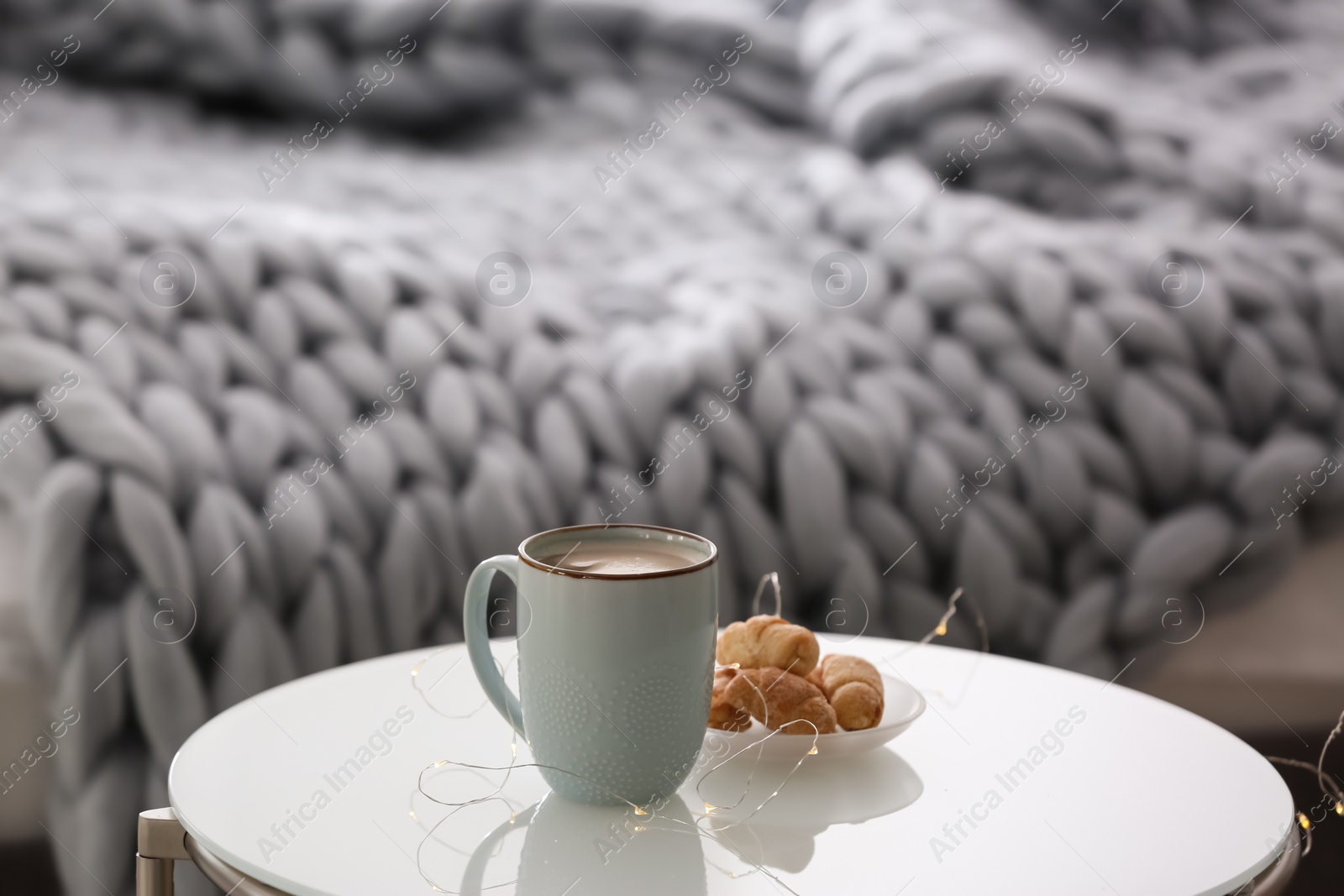 Photo of Cup of coffee and plate with croissants  on table