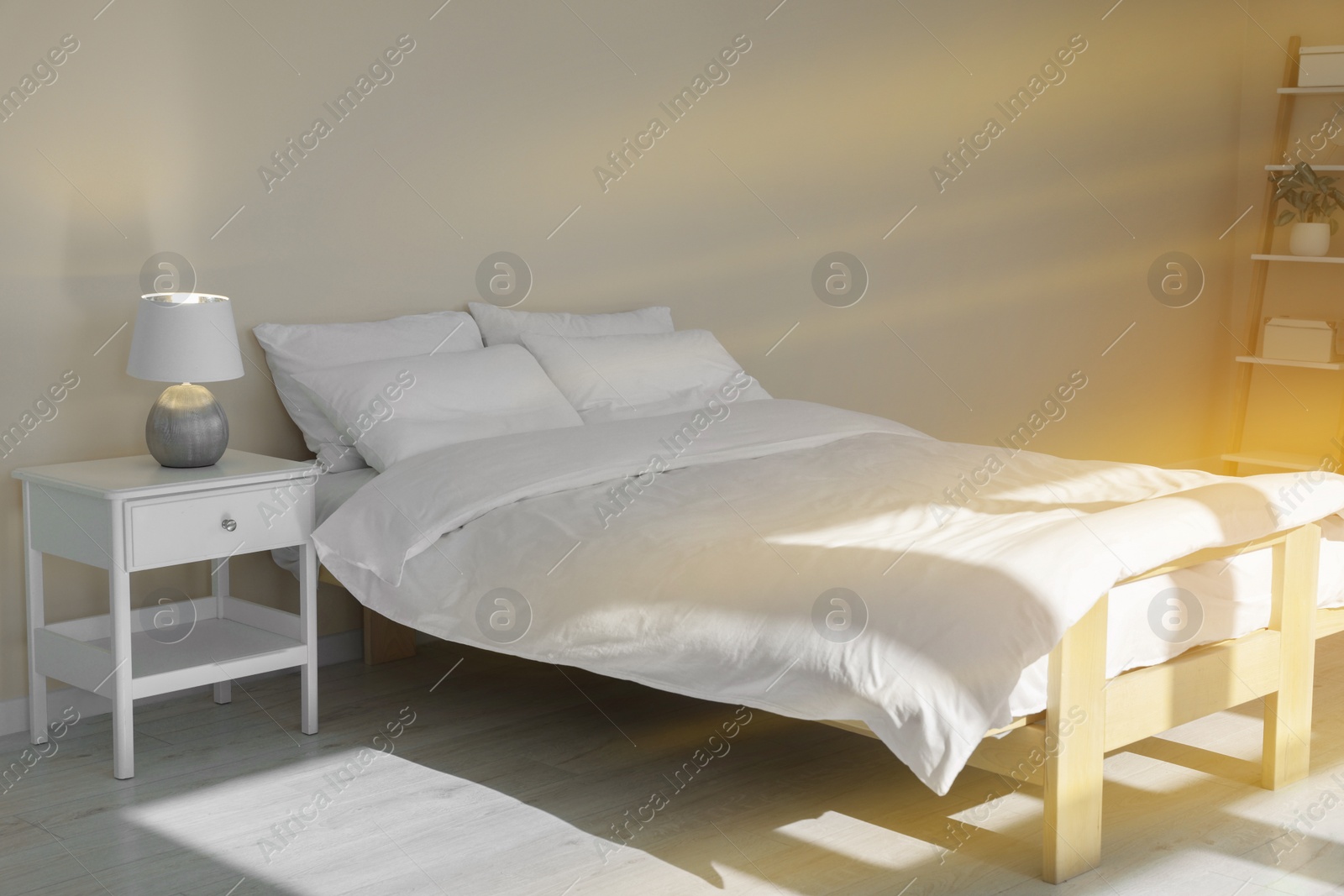 Photo of Bed with soft white pillows in cozy room interior