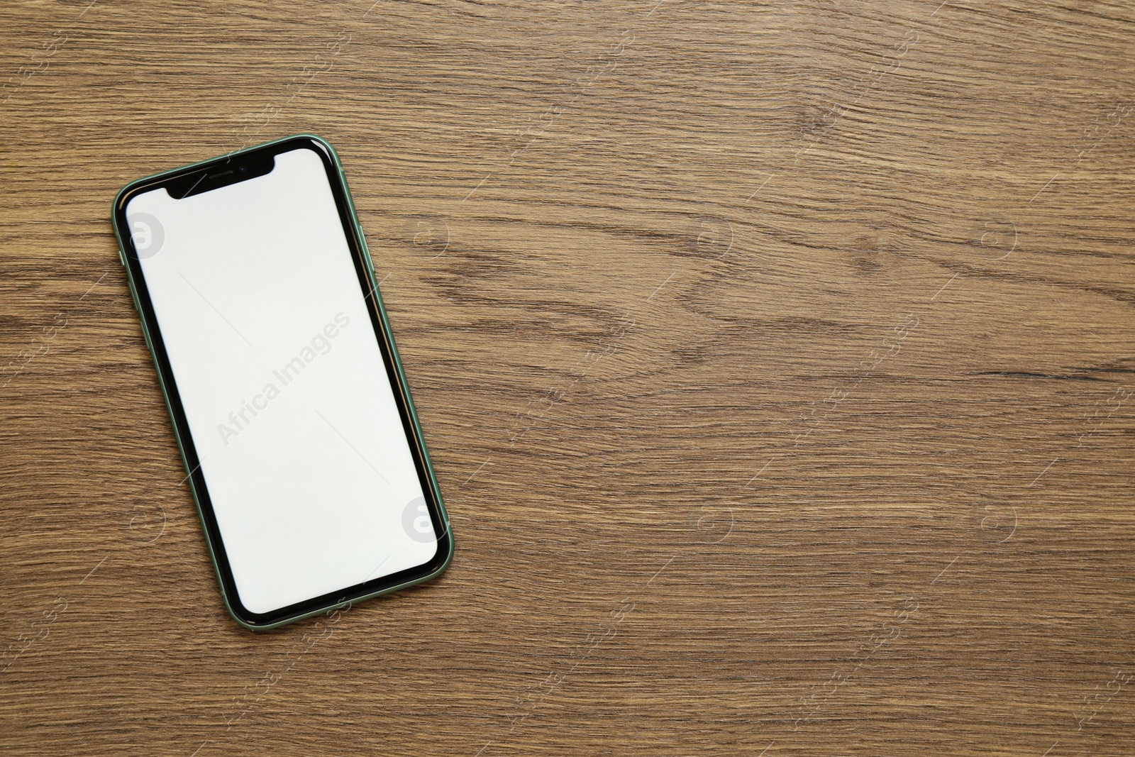 Photo of MYKOLAIV, UKRAINE - JULY 07, 2020: iPhone 11 on wooden background, top view. Mockup for design