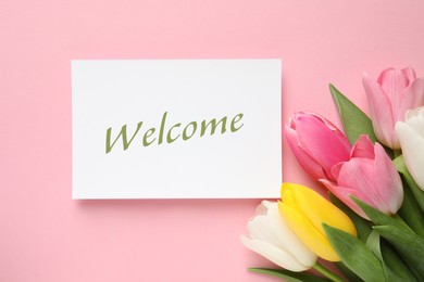 Image of Welcome card and beautiful tulips on pink background, top view
