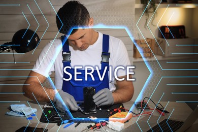 Image of Technician repairing broken smartphone at table indoors