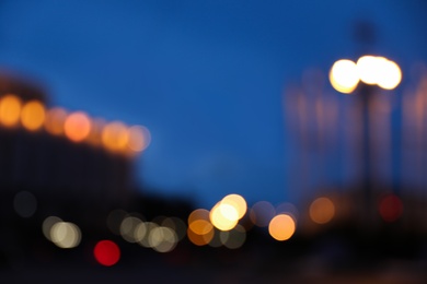 Photo of Blurred view of modern city at evening. Bokeh effect