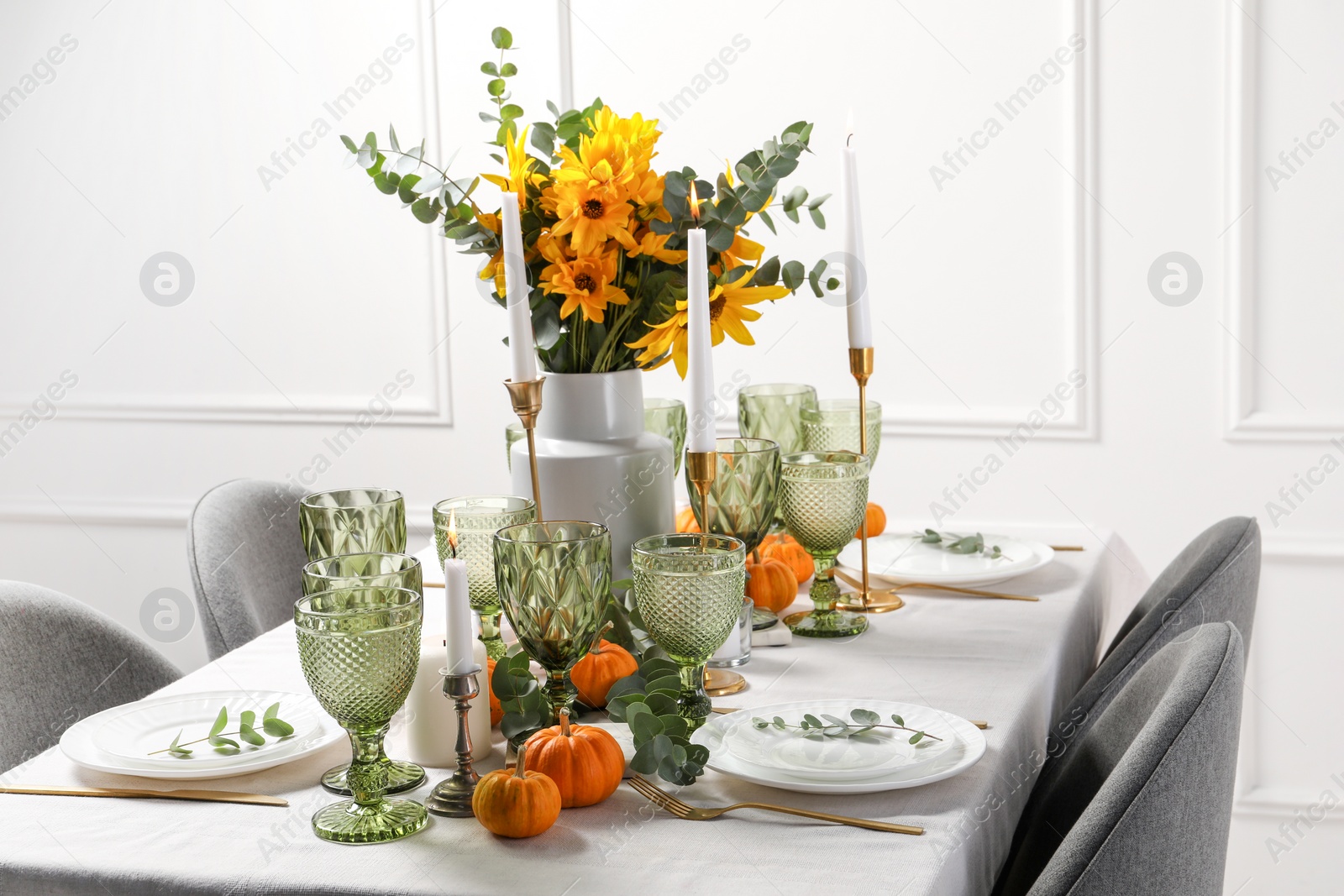 Photo of Beautiful autumn table setting with bouquet indoors. Plates, cutlery, glasses and floral decor