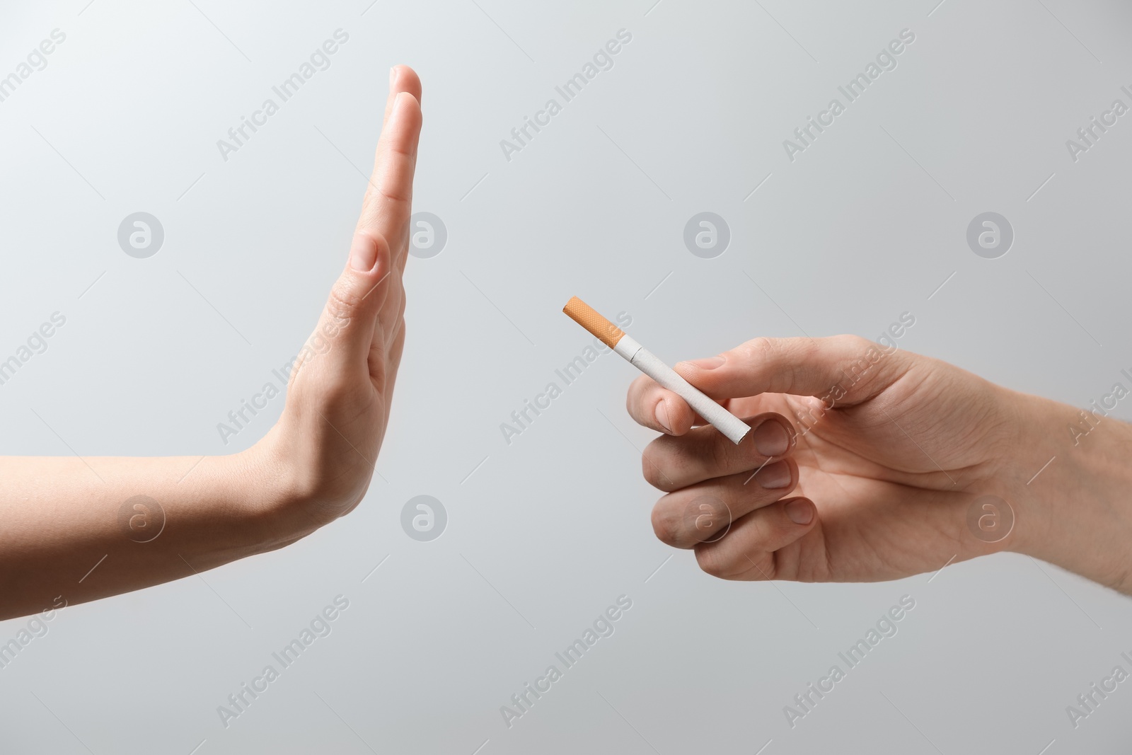 Photo of Man refusing cigarette on grey background, closeup