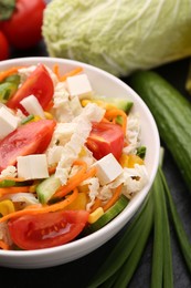 Photo of Tasty salad with Chinese cabbage served on table, closeup