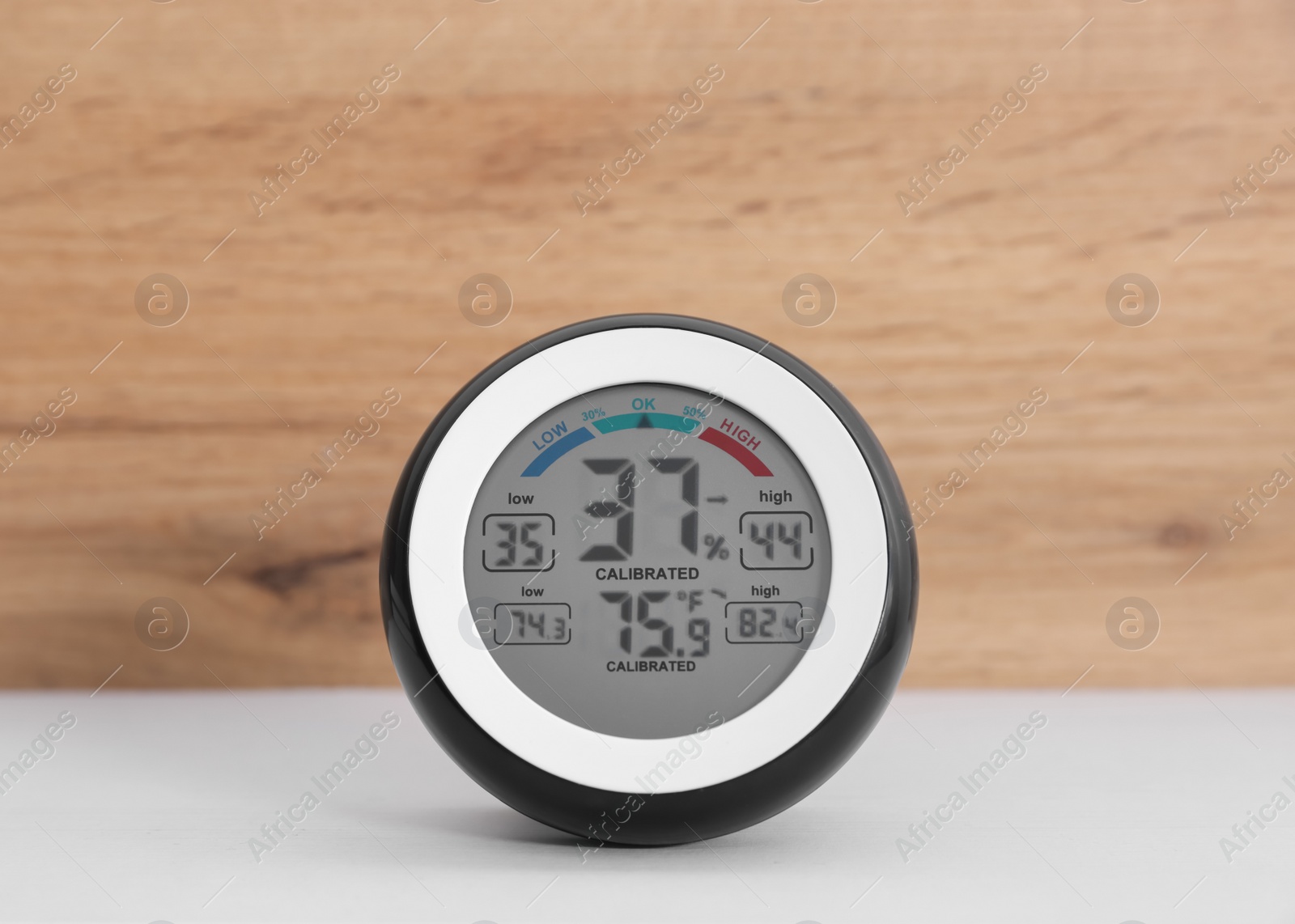 Photo of Digital hygrometer with thermometer on white table